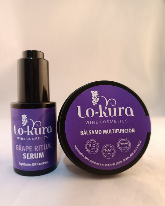 frasco negro de cristal con etiqueta morada en la que se lee grape ritual serum junto a lata negra circular con etiqueta morada en la que se lee lo-kura wine cosmetics bálsamo multifunción sobre fondo neutro